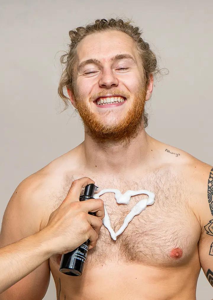 Rebel care we love gingers body care with hand applying foam in heartshape to mans chest