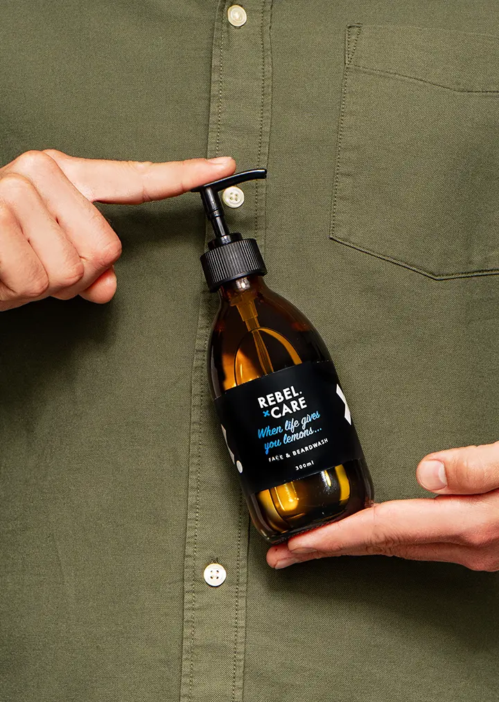 Man holding Rebel care When life gives you lemons face and beard wash refill